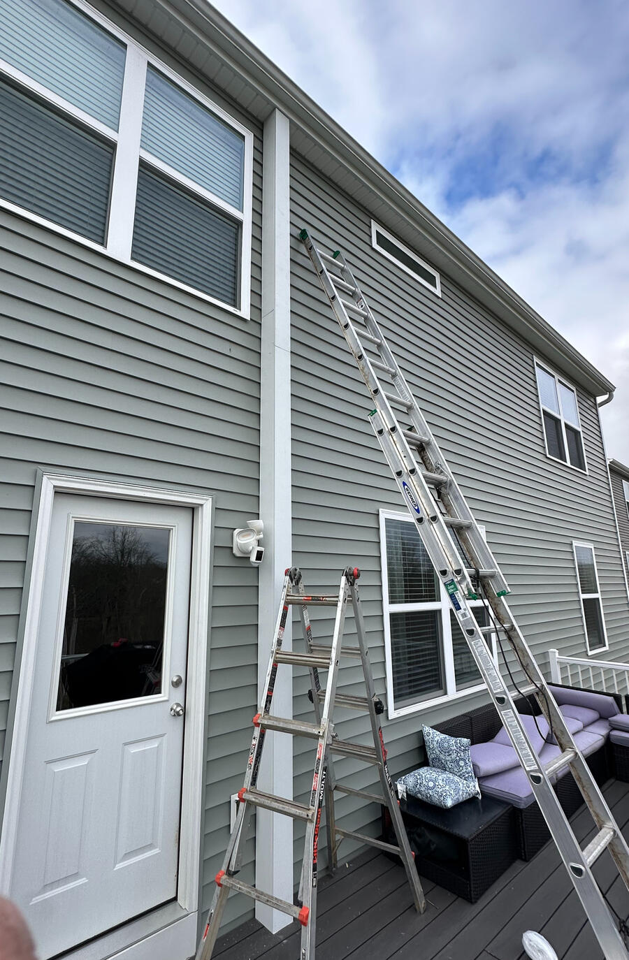 Side-by-side comparison of a house with a bright, sunny sky on the left and a dark, stormy sky and damaged roof on the right.